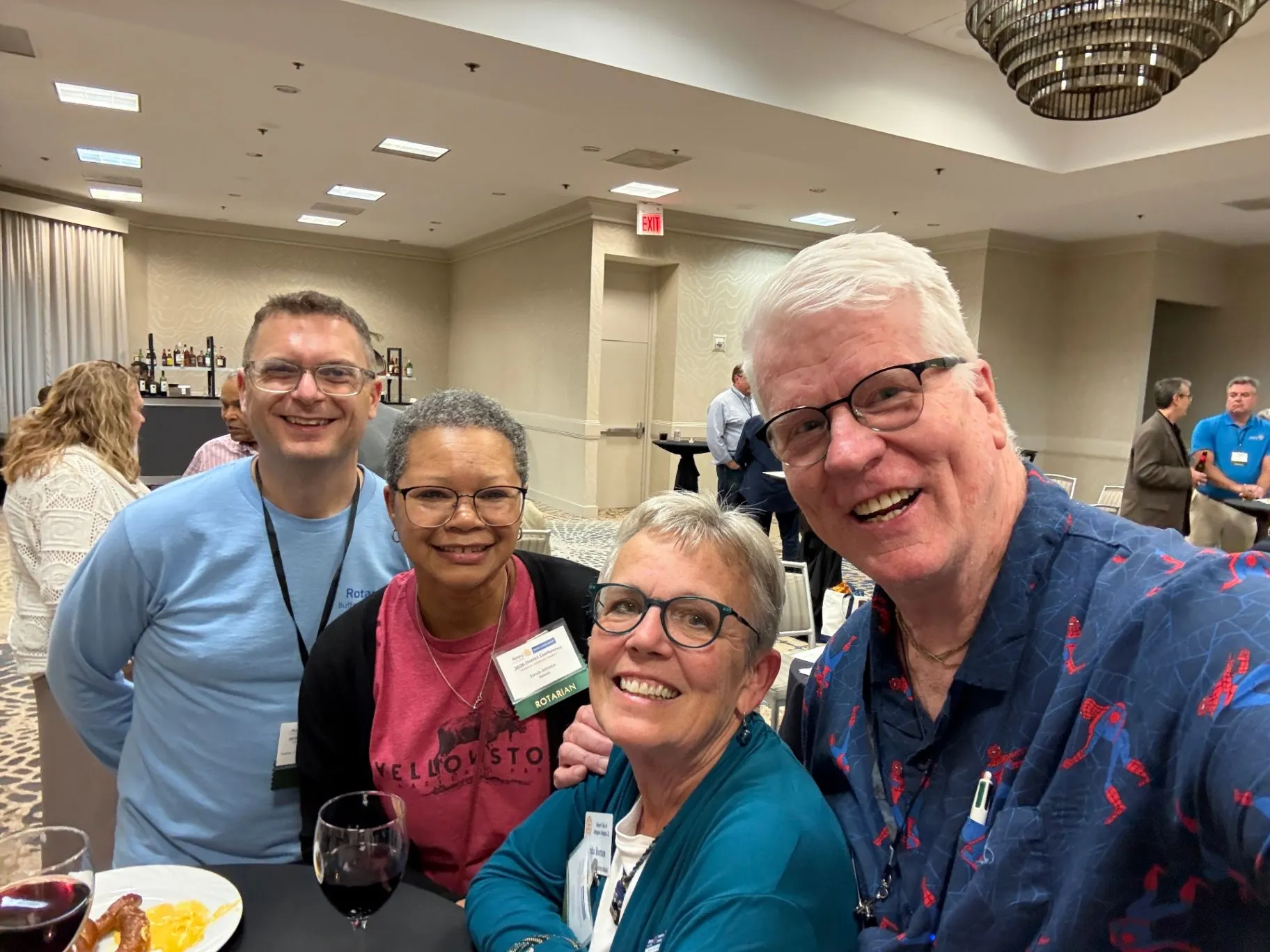 Michael Shoultz smiling with three people at an event